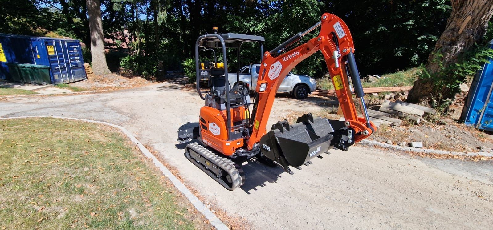 Mini excavator on a gravel access track