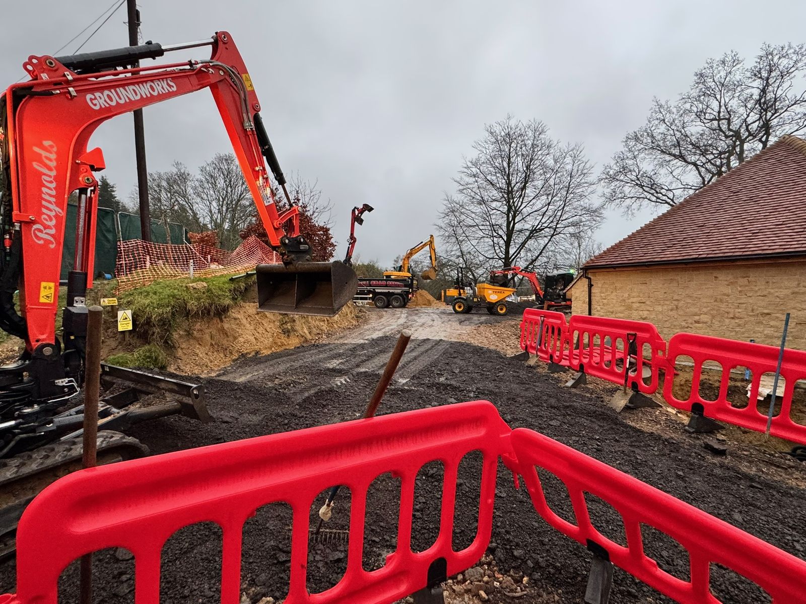 Reynolds excavator working on a fenced building site