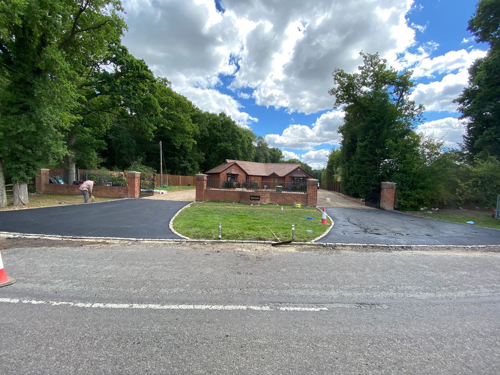 Newly surfaced private estate road with brick gate piers and lodge